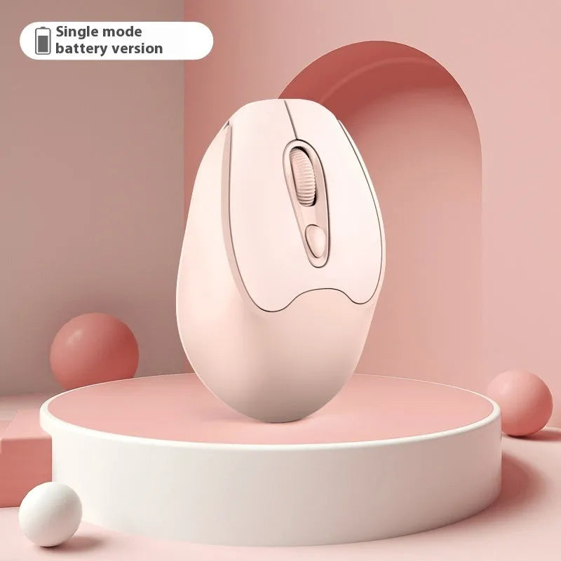 Bluetooth wireless mouse in choice of girl pink, milk tea pink, grey or green colours on a desk next to a laptop.