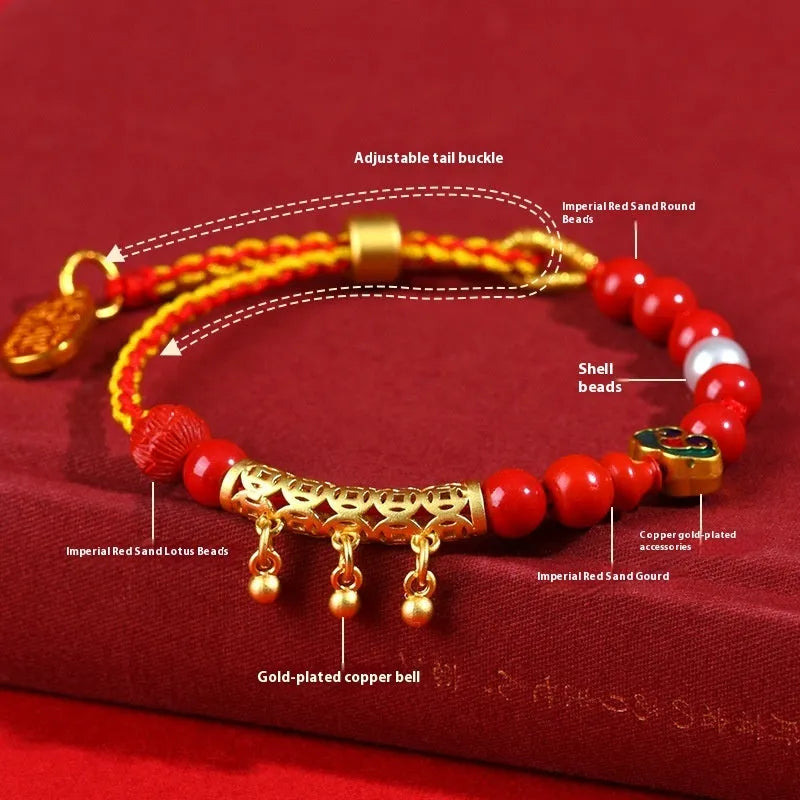 Women's hand-woven cinnabar rope bracelet with round bell charm in emperor red sand colour