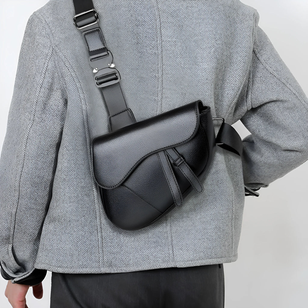 Unisex saddle shoulder crossbody chest bag made of synthetic leather with stitching detail in black