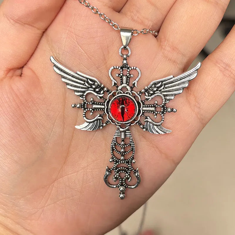 Close-up of a devil wings and cross design alloy pendant necklace on a chain, shown in a choice of colours.