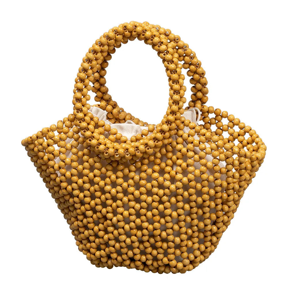 Hand-woven dumpling-shaped handbag with wooden beads in milky white colour