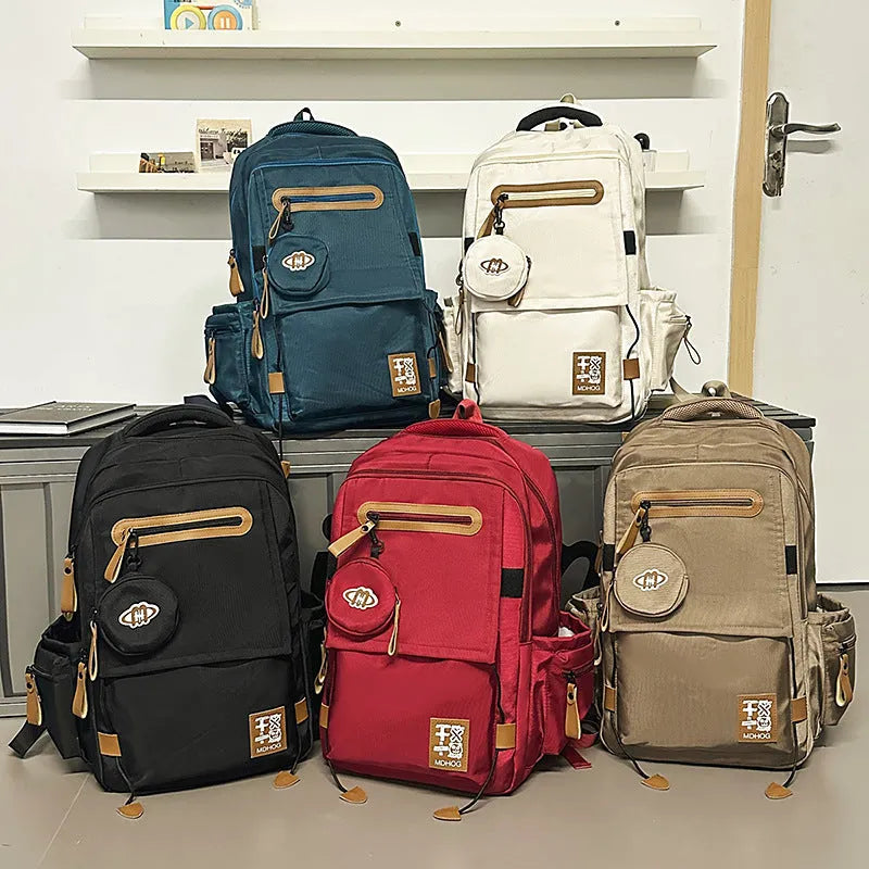 Large black waterproof nylon travel backpack with contrast stitching, shown with a 20-35L capacity.