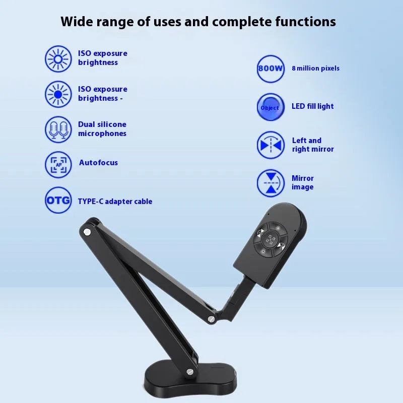 Black USB computer webcam with microphone on a desk, showing its compact design and attached data cable.