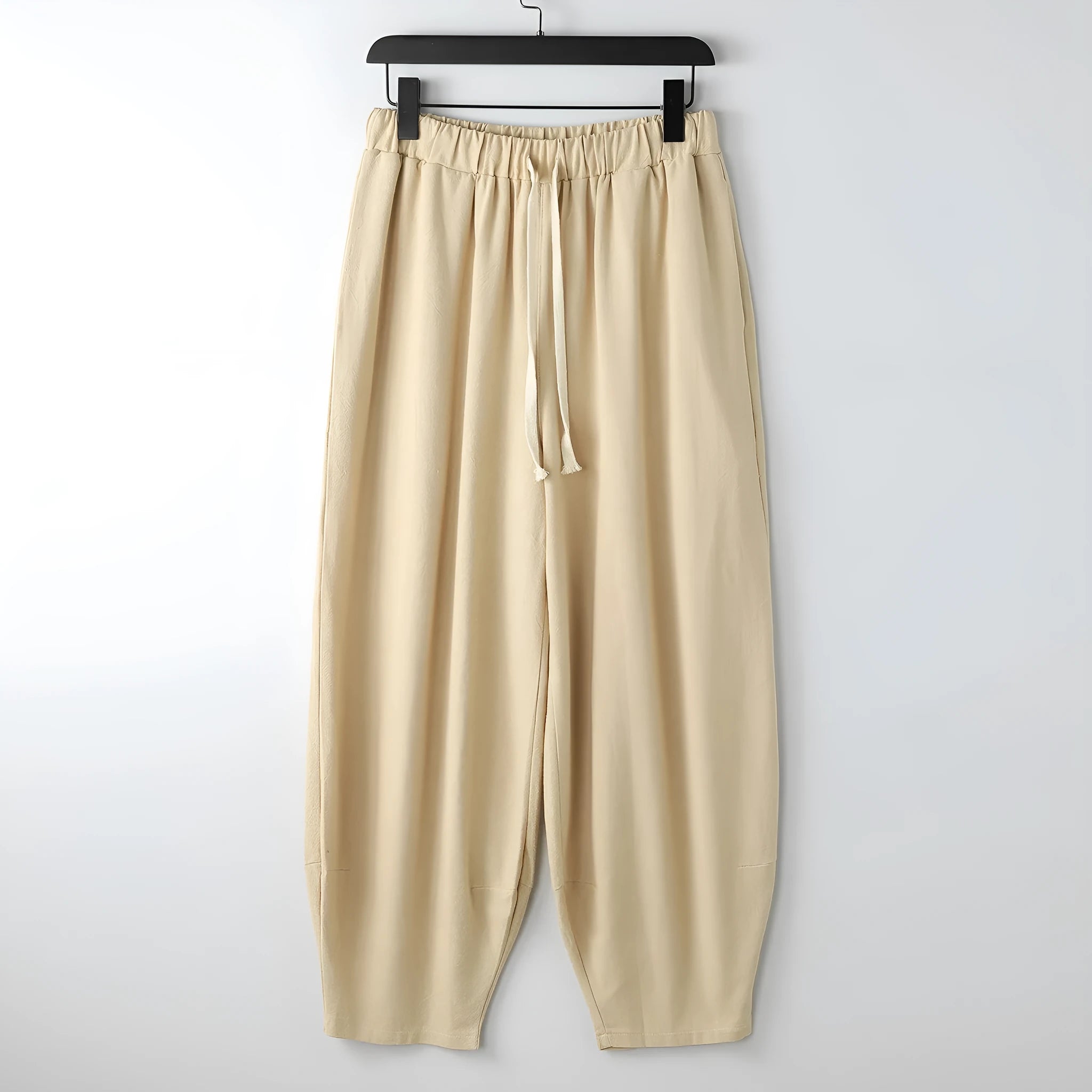 Men's linen harem pants with ankle ties in tapered loose fit on larger model