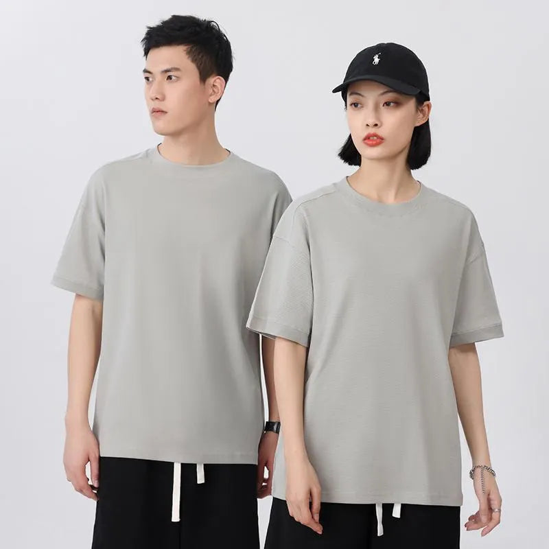 Men's loose grey cotton short-sleeved t-shirt on a hanger, casual summer wear.