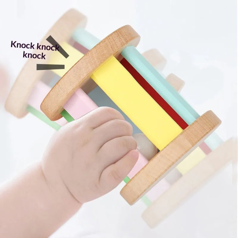 Wooden infant rainbow rattle with rainbow rolling bell, 7.5x7 cm size, on a white background
