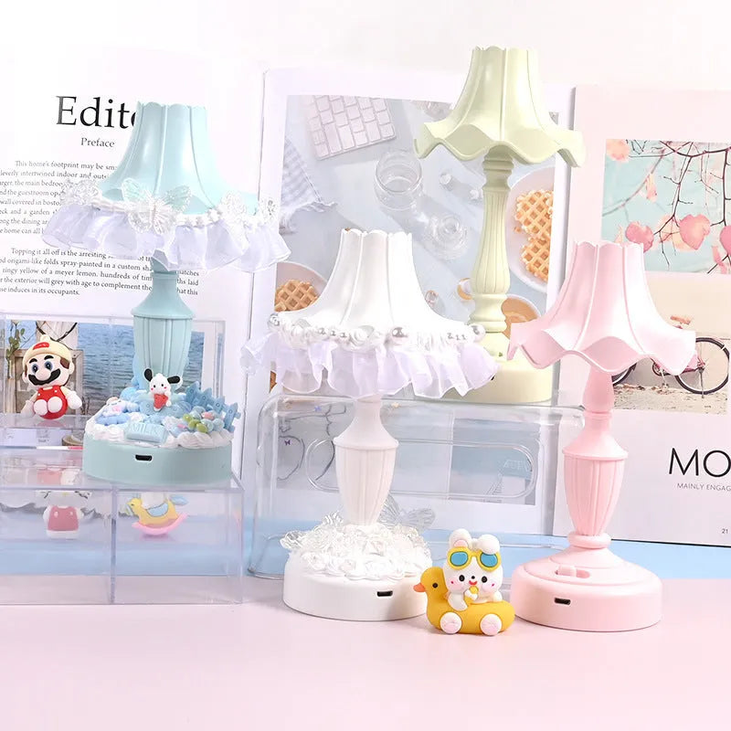 Cute cream retro table lamp with pink floral accents on a desk