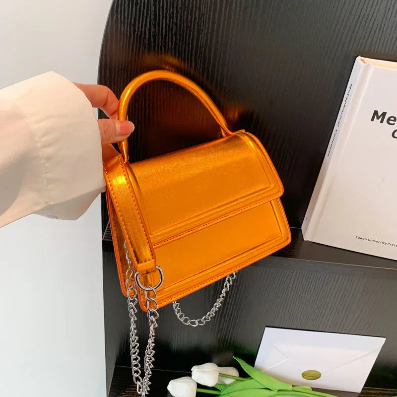Retro square crossbody bag in PU leather with sewing line details, shown in a selection of colours.