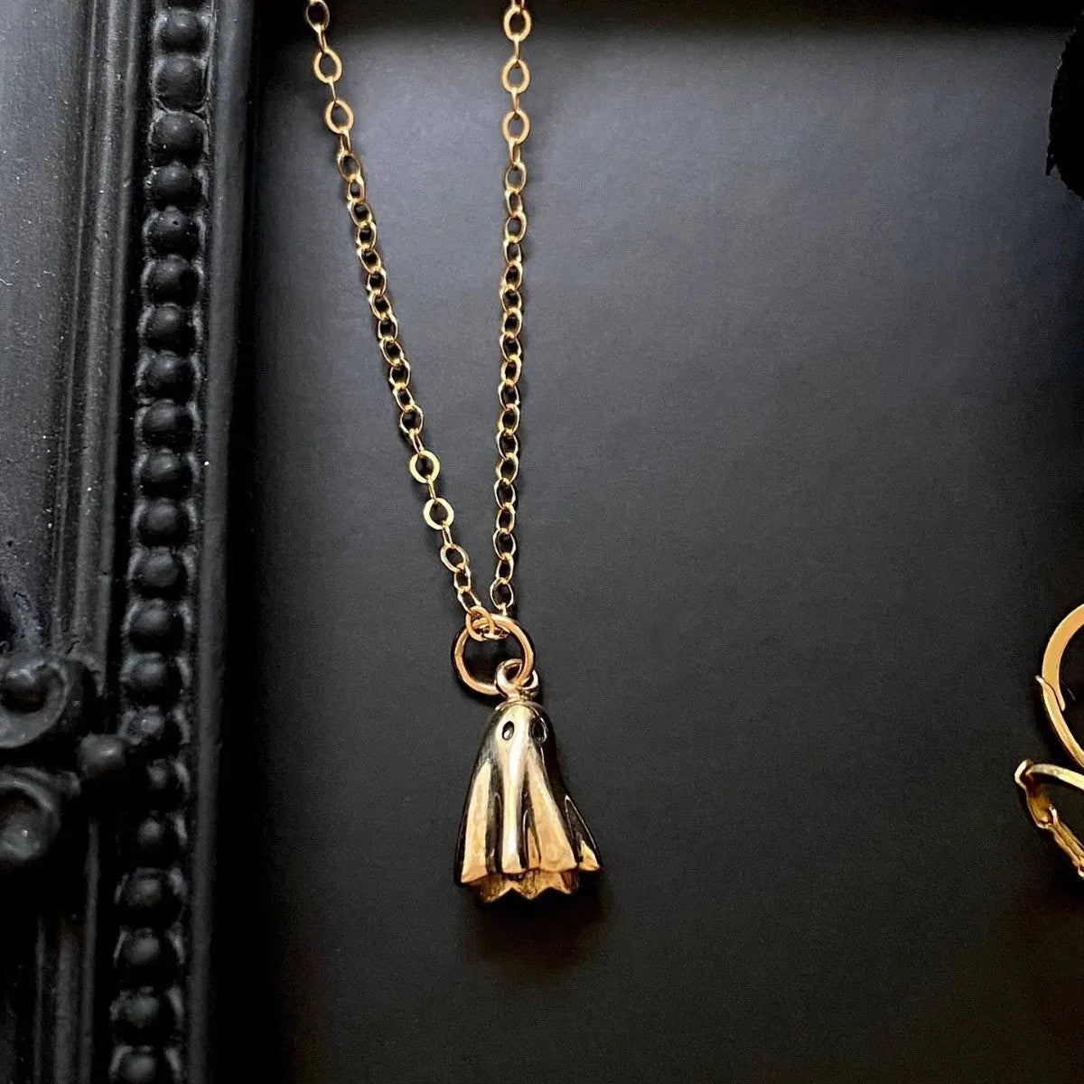 Ghost pendant necklace on a twisted stainless steel chain, shown in Cable, Figaro, and Mini Staple style options.