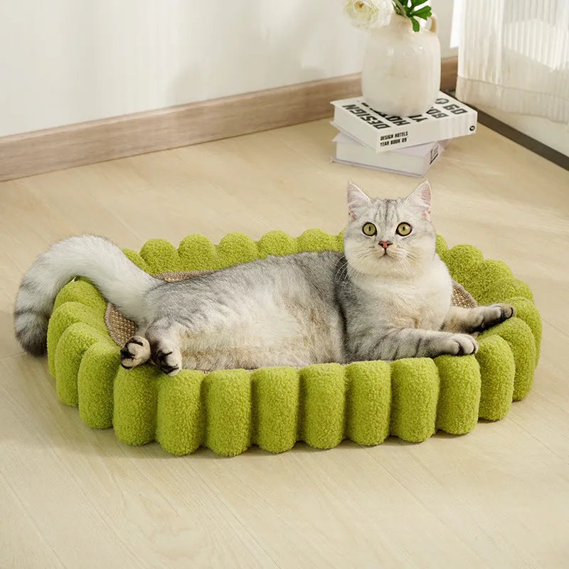 Green oval cat scratcher bed made of sisal, showing scratching surface and lounging area.