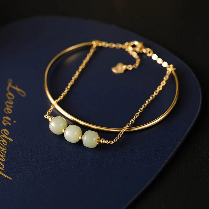 Women's jade lucky beads bracelet with gold inlay treatment in single, double, and three bead styles.