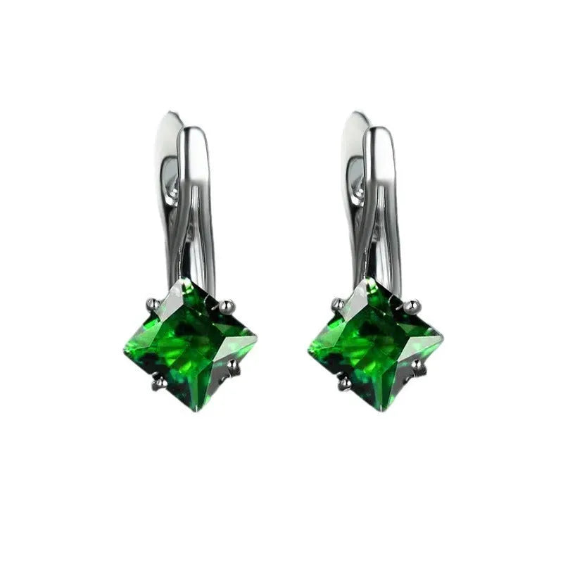 A pair of copper diamond-shaped earrings with inlaid zircon stones, shown in blue, green, and colour variants.