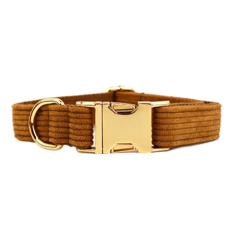 Caramel corduroy pet collar set with ring, rope, bow, vest, and poop bag on a light background