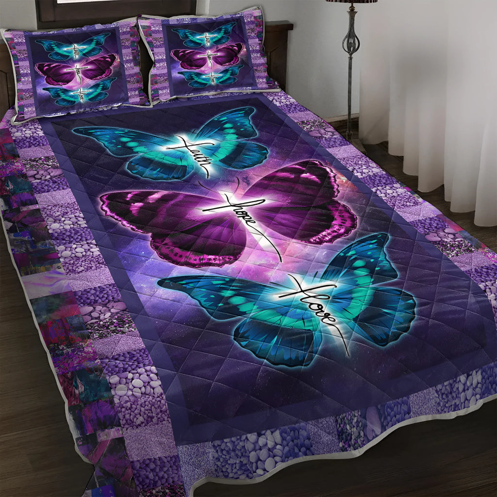 Purple 3-piece butterfly patterned quilt set with quilt and two pillow shams on a bed