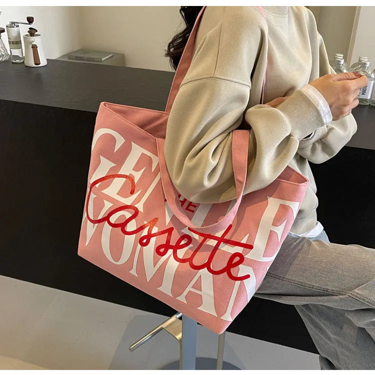 Letter printed canvas tote bag in off white with car stitching detail and top handles