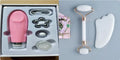 White jade facial roller and gua sha tool set with rose quartz board on a neutral background.