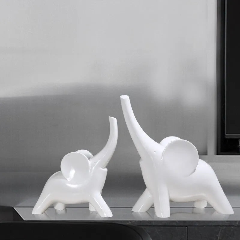 Modern resin elephant ornament in rose gold colour with raised trunk on display surface