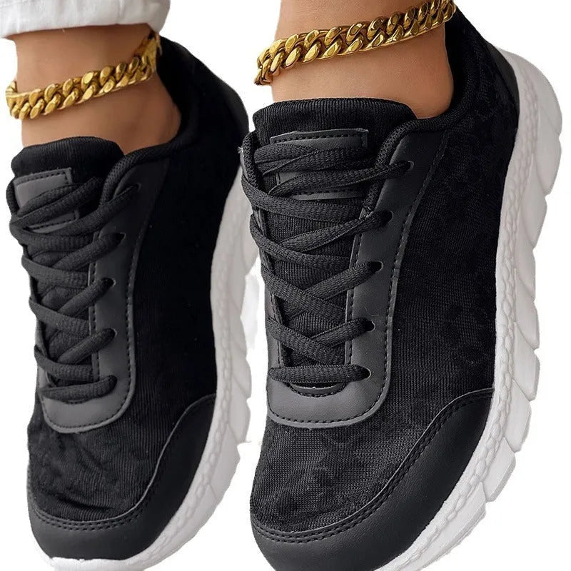 Women's canvas sports shoes in white colour showing flat heel design and round toe shape