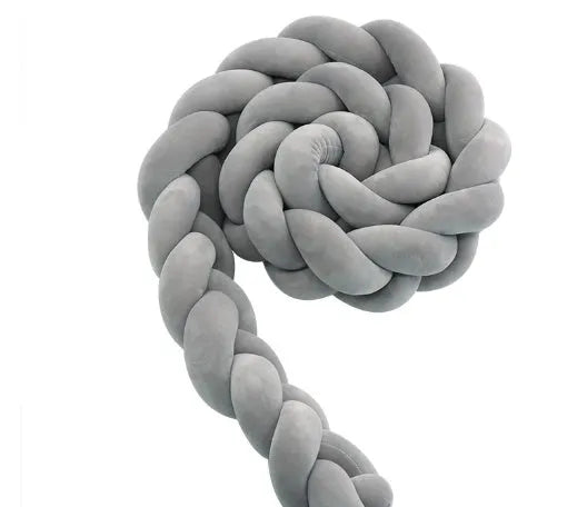 Baby cot bumper braid in spandex crystal velvet, shown in a light grey colour, wrapped around white crib rails.