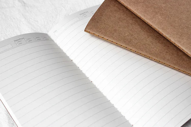 Cowhide diary refill inner core showing saddle stitch binding and 100g ivory white paper