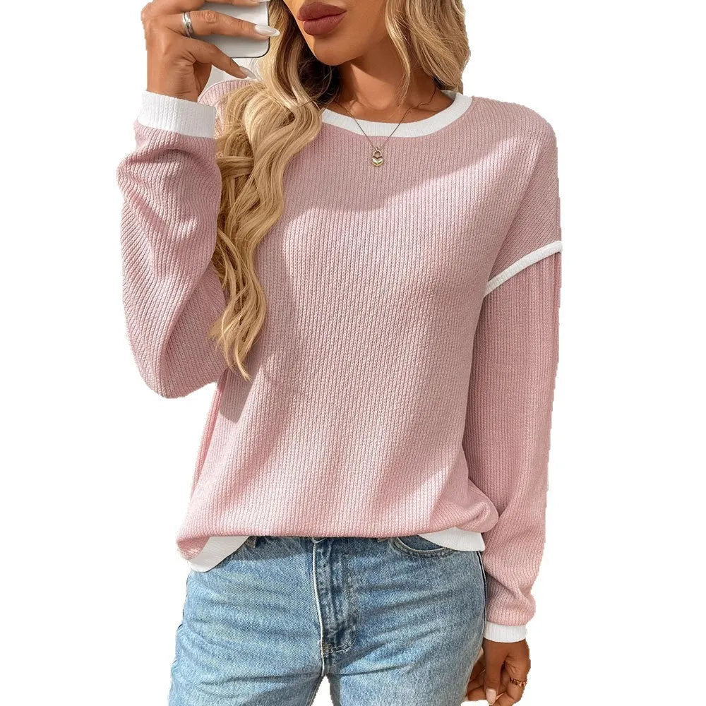 Women's loose-fit round neck long sleeve polyester pullover top on a hanger.