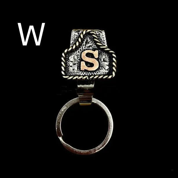 Handmade metal cow tag style key holder shown in one of its 26 colour options, attached to a keyring.