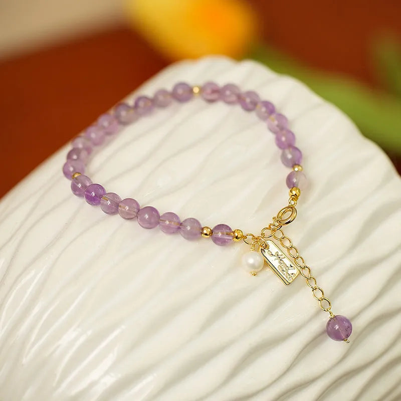 Natural crystal women's bracelet with lavender amethyst stones and animal/Zodiac motif in dark and light colour variations