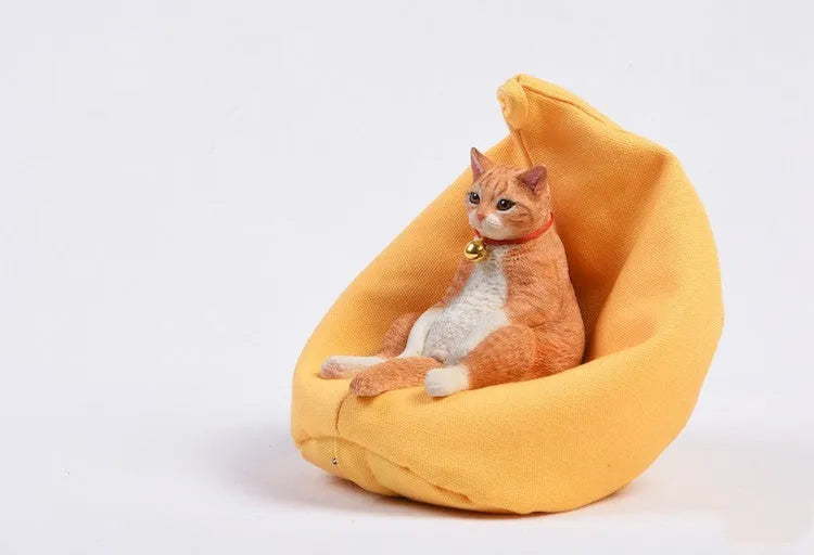 Small lazy cat model resting on a sofa, a resin car dashboard ornament decoration.