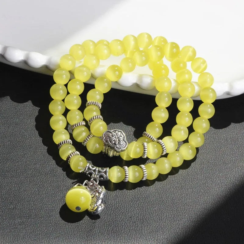 Opal crystal cat eye bracelet with lucky cat charm, shown in one of six colour options.