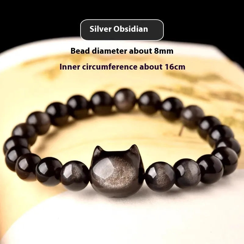 Obsidian cat head bracelet with round beads in gold or silver style, showing cat charm detail.