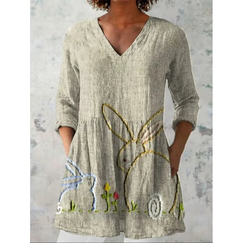 Women's floral wave print dress with wide waist and three-quarter length sleeves on a hanger.