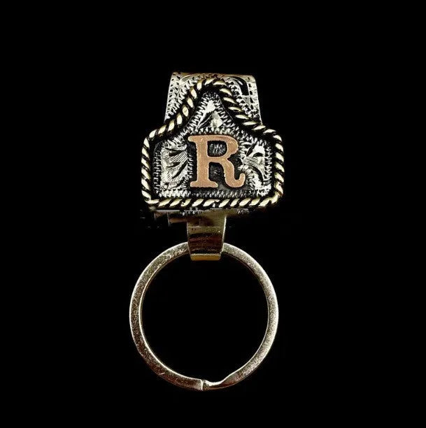 Handmade metal cow tag style key holder shown in one of its 26 colour options, attached to a keyring.