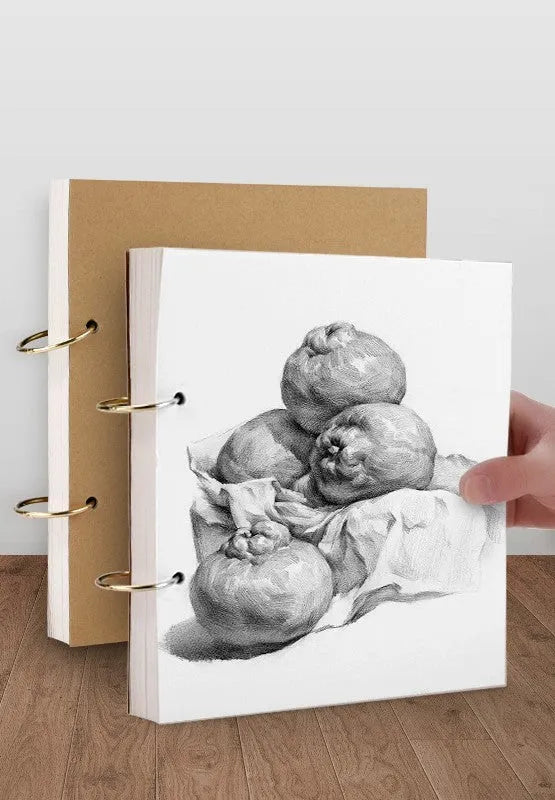 8K thickened sketchbook open on a table with marker drawings, showing linen and black card cover options.
