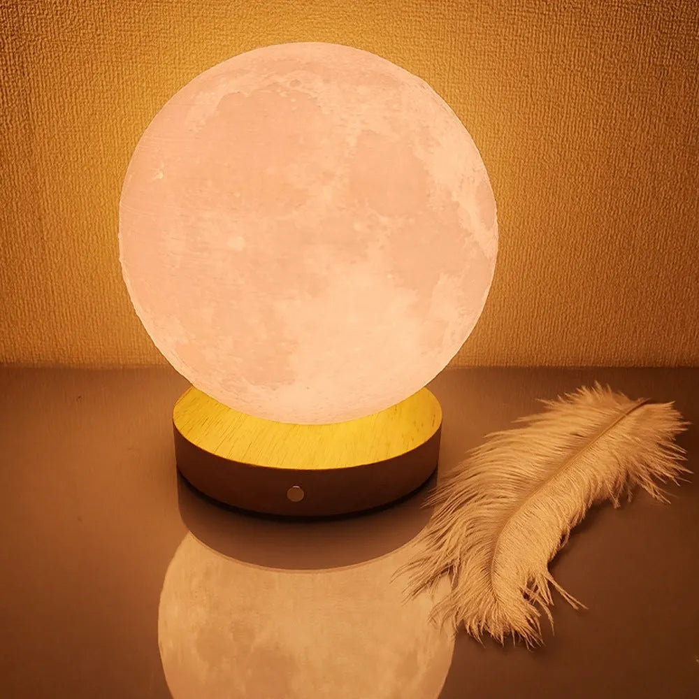 Rotating three-colour moon night light on a wooden base, showing 12cm, 15cm, and 18cm size options.