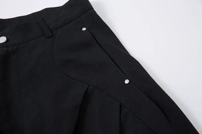 Black men's pleated casual trousers with a loose wide-leg fit on a hanger
