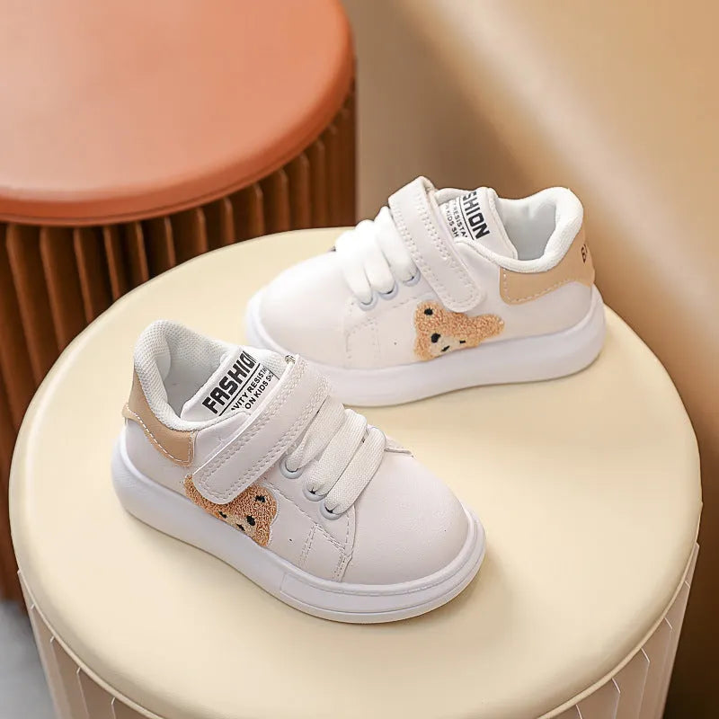 Children's black cartoon bear casual sports shoes with artificial leather upper and rubber sole.