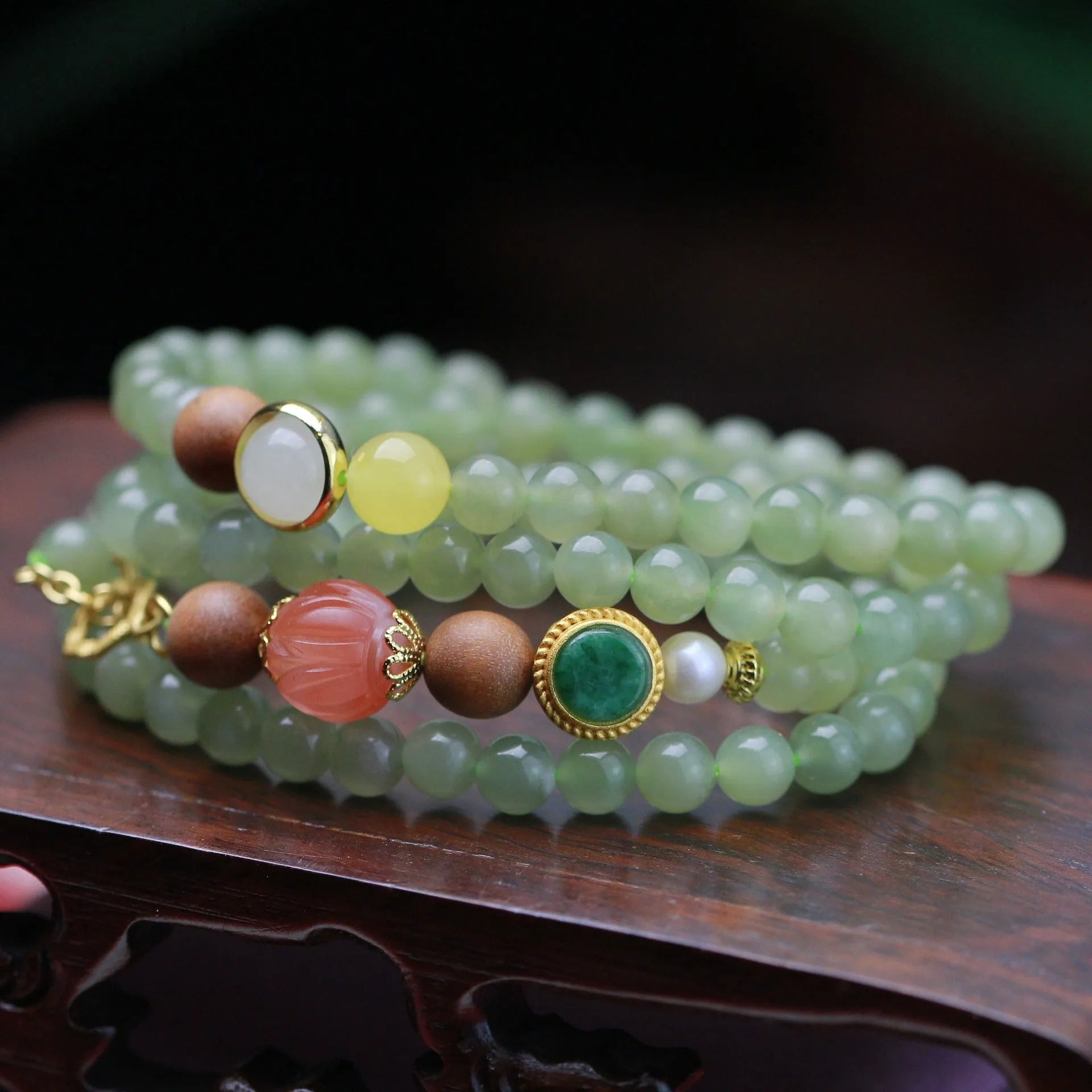 Hetian jade necklace with lotus beads, zodiac charm, and matching bracelet on white background