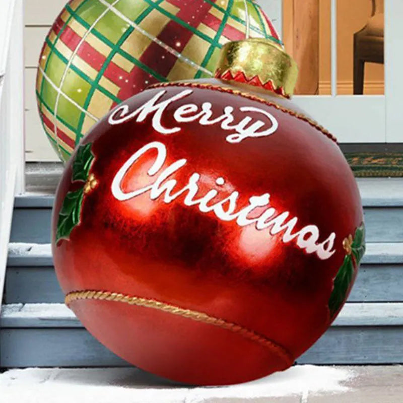 Large red and white striped inflatable Christmas ball ornament hanging on an outdoor tree
