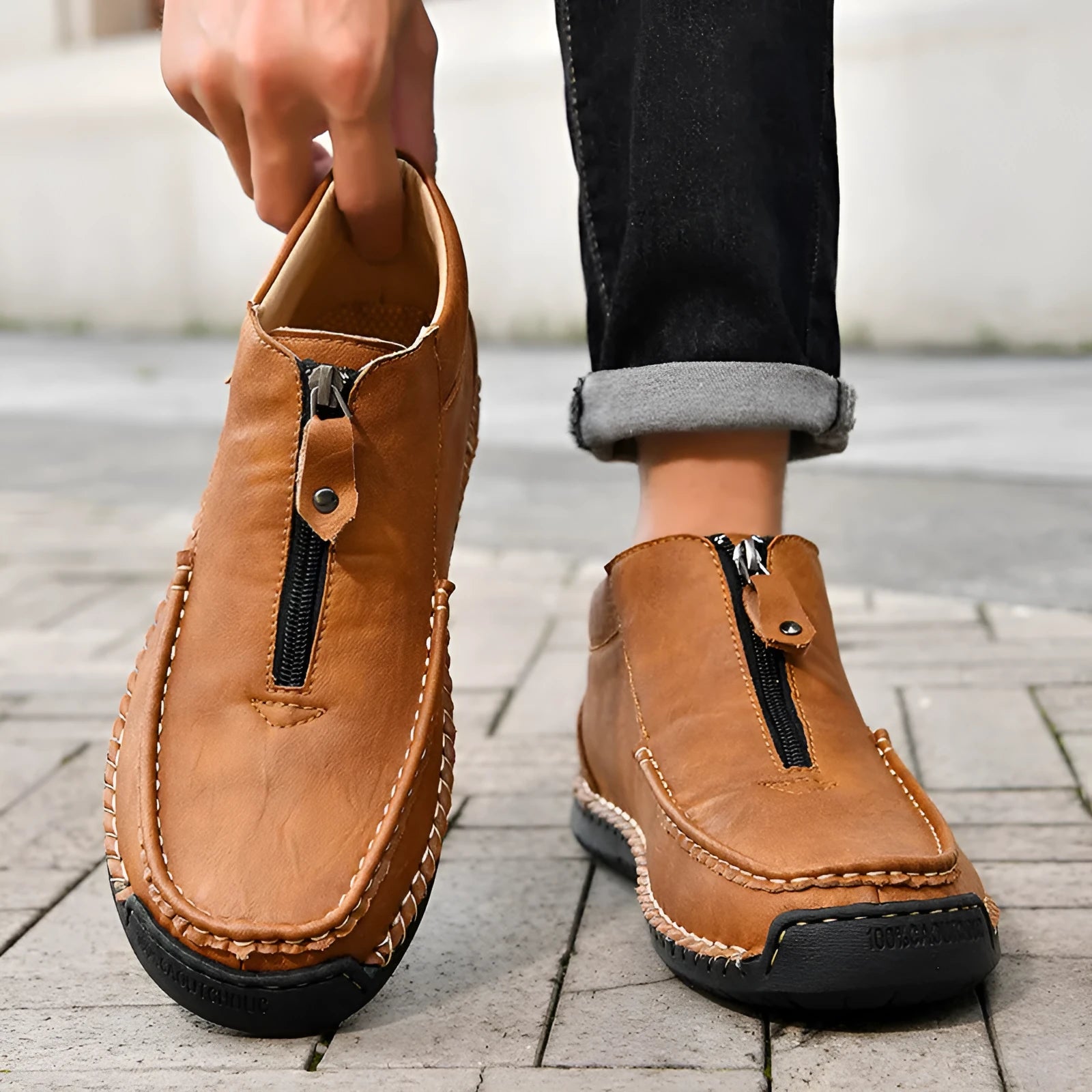 Men's black slip-on loafers with round toe and visible stitching on a rubber sole.