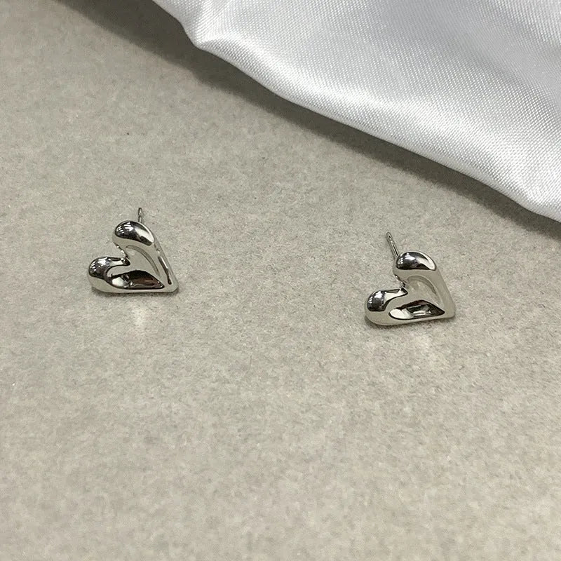 Simple heart-shaped metal drop earrings in gold and silvery colour options