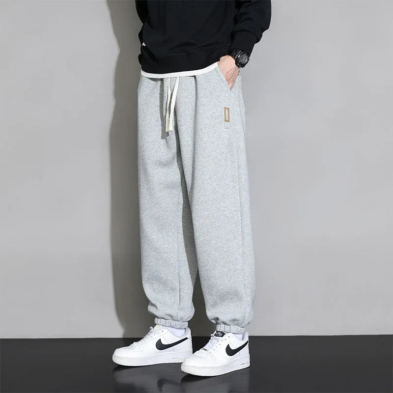 Men's loose fit sports trousers in grey colour with elastic waistband and drawstring closure