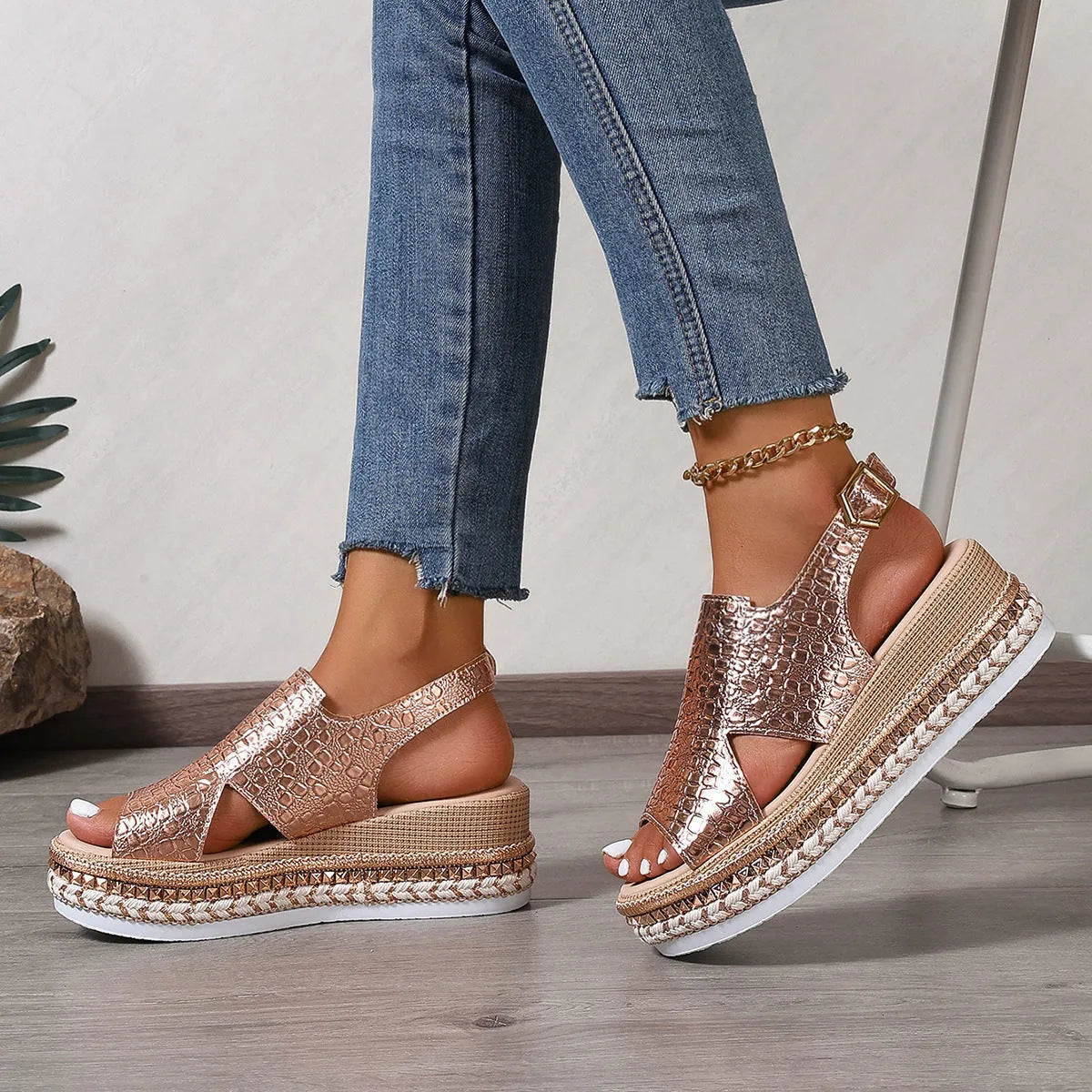 Gold Roman sandals with round toe, hollow-out design, and ankle buckle on rubber sole