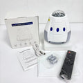 Space capsule shaped projection lamp showing galaxy lighting effects on wall, available in Space Grey or Space White finish