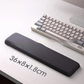 Square black silica gel wrist rest mouse pad on a desk, showing cloth surface and raised support pillow.