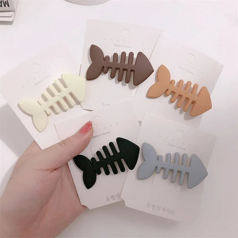 Fishbone pattern plastic barrette with duckbill clip in minimalist candy colour