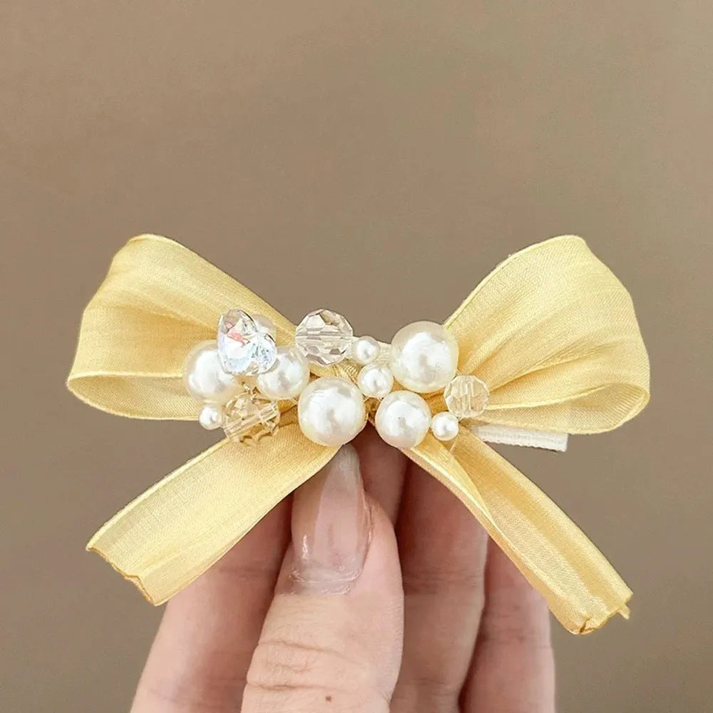 Yellow cloth bow hair clip with rhinestone and pearl decoration on duckbill hair grip