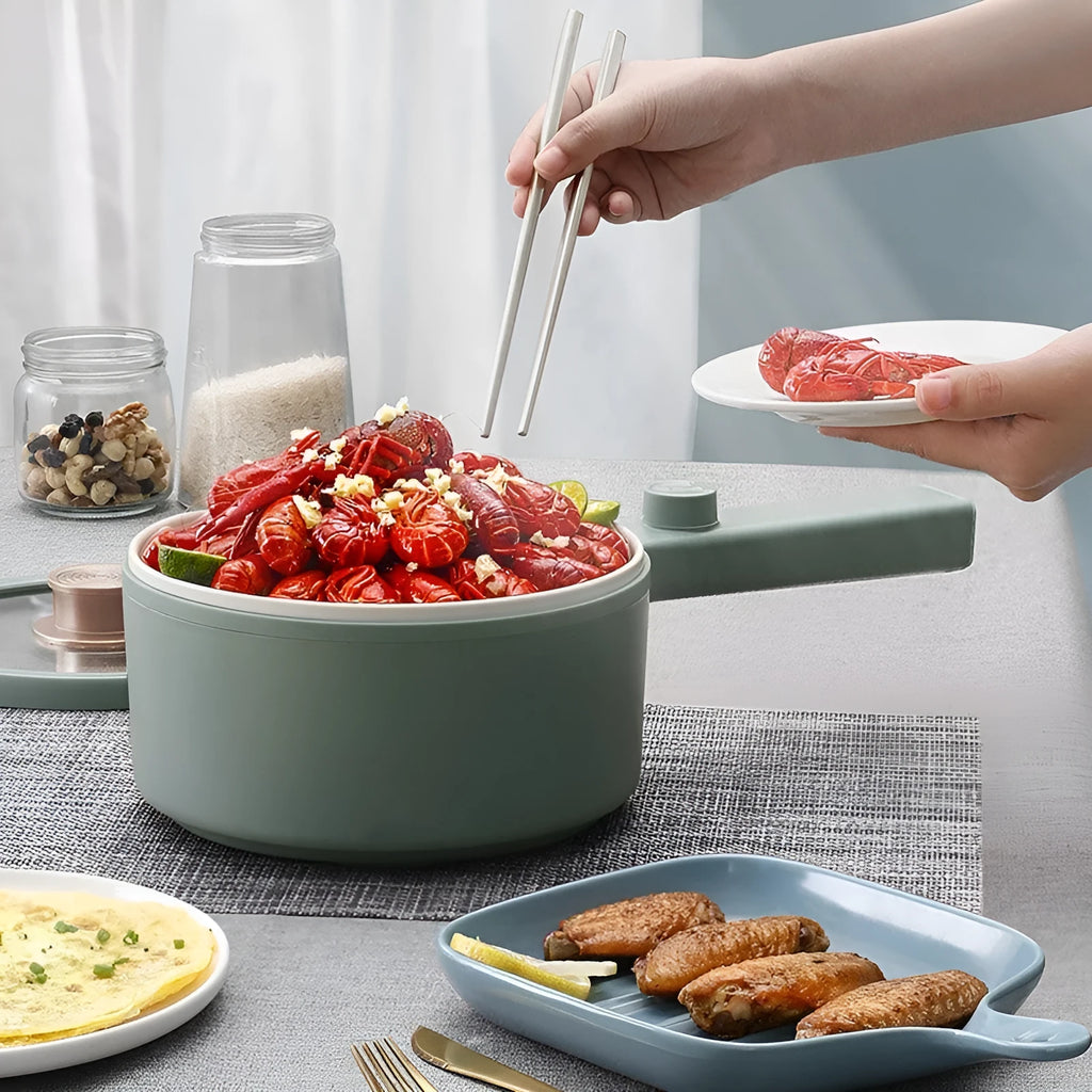White and green multi-function electric cooking pot with control panel, 600W power, and compact design.