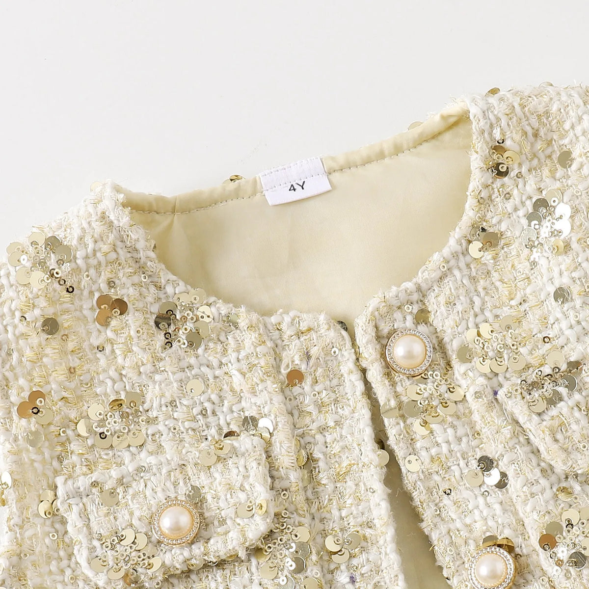 Apricot floral print long sleeve cotton blouse and short skirt children's two-piece set on a white background