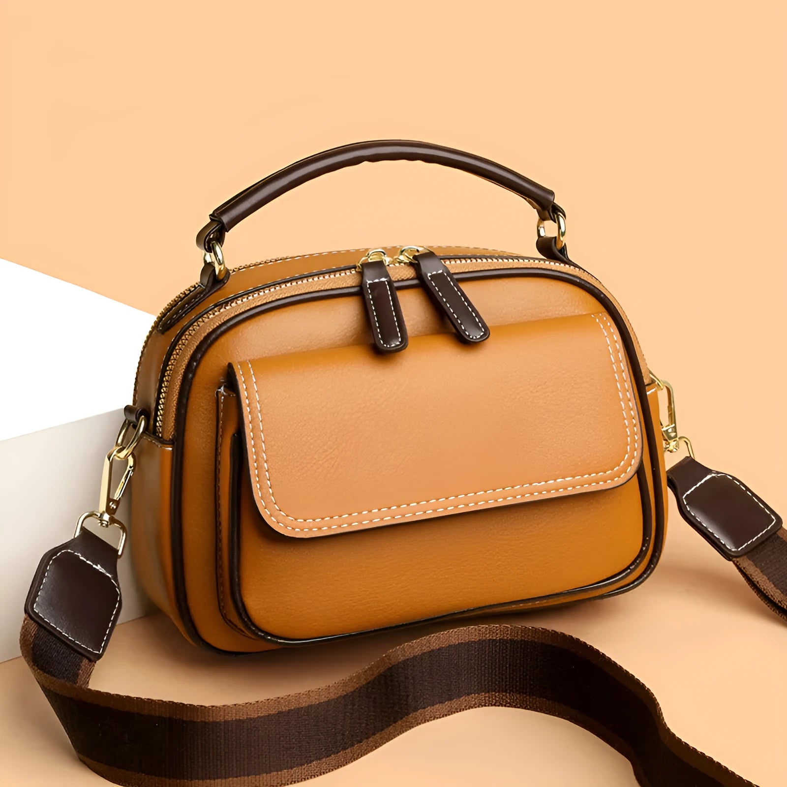 Black women's cross-body PU shoulder bag with adjustable straps showing its square shape and size.