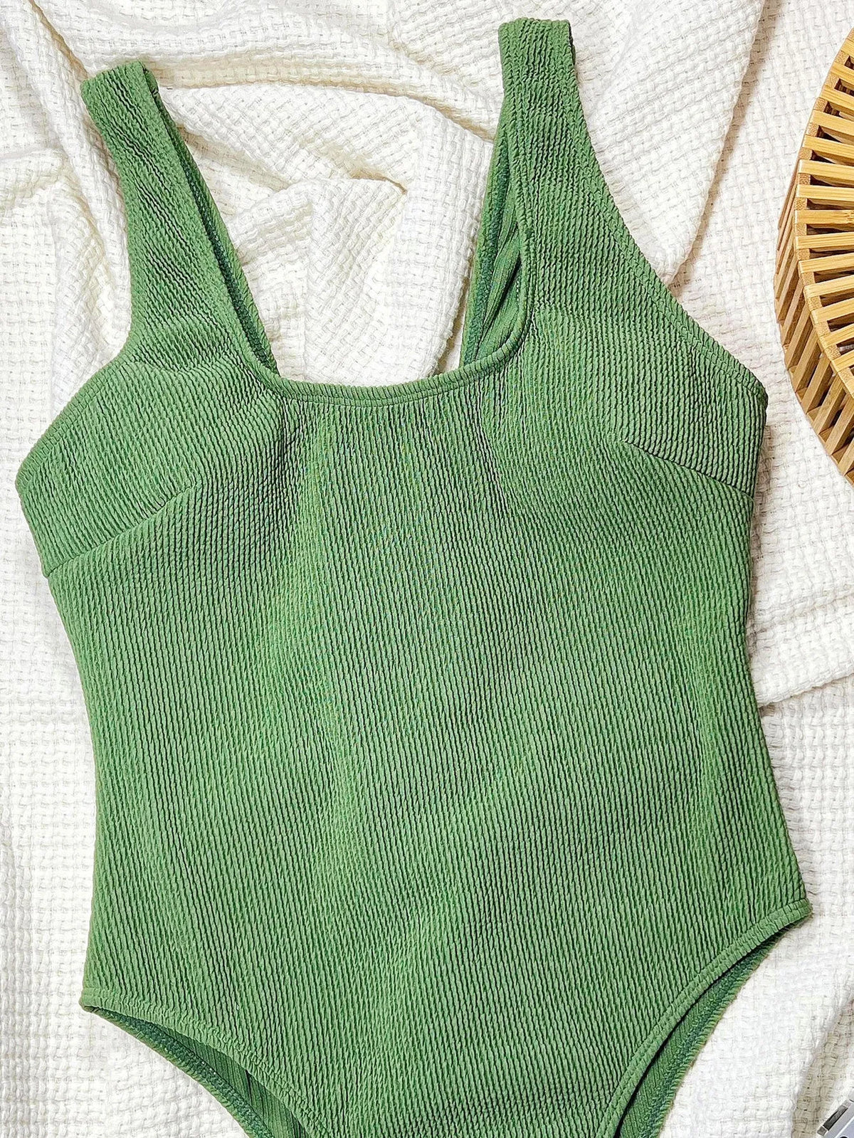 Women's solid green one-piece swimsuit made from polyester for swimming and wading, available in sizes S M and L